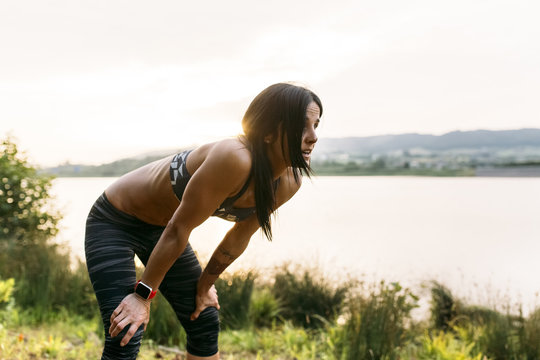 Woman taking breather while running outdoors