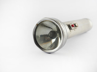 Old metal flashlight isolated on white,Antique flashlight