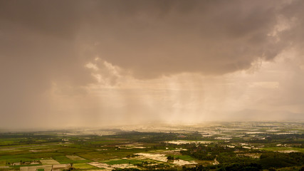 Fototapeta na wymiar Rain curtaining a view of the mountains.Rain storm over Rice fie
