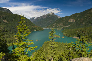 Fototapeta na wymiar Diablo Lake. Created by Diablo Dam, the lake is located between Ross Lake and Gorge Lake on the Skagit River. The unique, intense turquoise hue is from glacial rock ground to a fine powder.