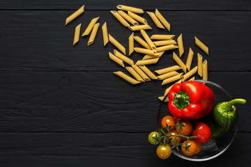 pasta and vegetables on black background