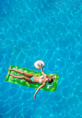 Beautiful young woman in bikini Relaxing in a pool