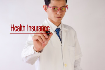 Blurred Doctor writing Health insurance text concept