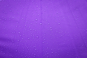 Naklejka na ściany i meble Abstract background of rain water drop on purple umbrella background