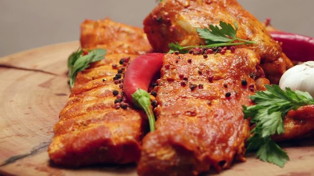 Fresh raw pork ribs with herbs and spices ready for cooking (rotating)