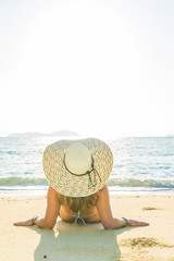 Woman in bikini and hat  at beach