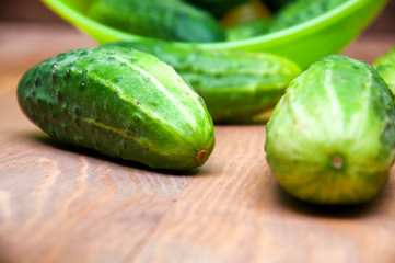 Mini cucumbers in bowl on table