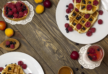 Two white plates with waffles  top view on the table