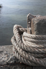 Fototapeta na wymiar anchor rope tie up the stone pillar