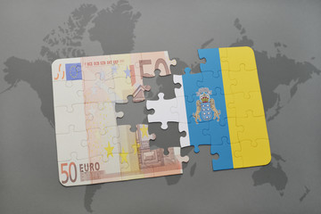 puzzle with the national flag of canary islands and euro banknote on a world map background.