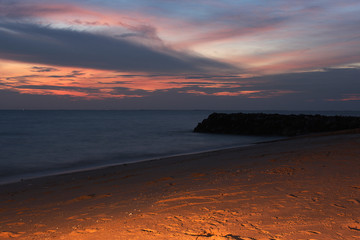 sunset scene on the beach with the light beam on the sky