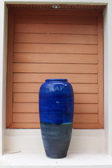 a decorate giant blue vase put on the gate