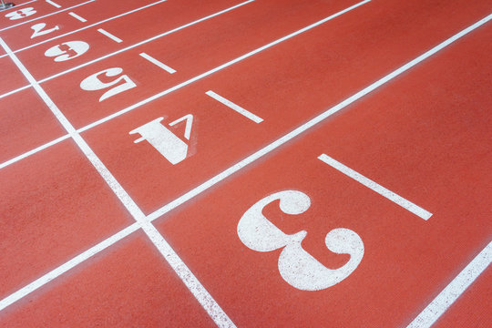 Red treadmill of special materials in the stadium with numbers starting position. Finishing or  section  the running track  numbered lanes.