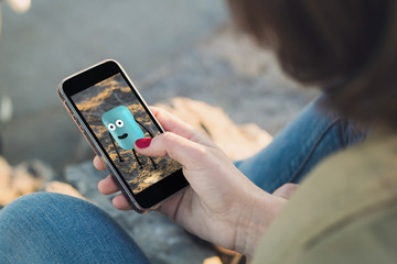 Woman catching monster with her smartphone