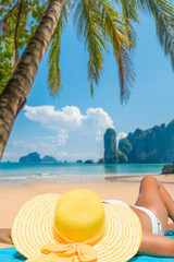 Fototapeta na wymiar Woman relaxing on a tropical beach