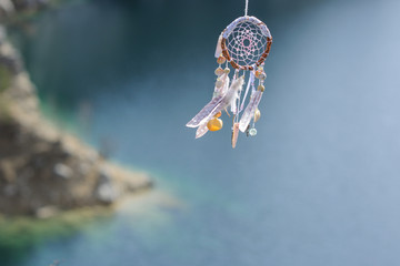 Handmade native american dream catcher on background of rocks an