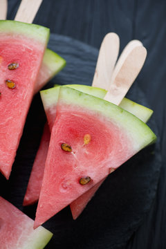 Close-up of sticks with fresh watermelon slices, high angle view
