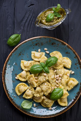 Above view of ravioli served with basil pesto sauce, close-up