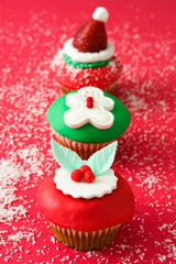 Christmas cupcakes on red background

