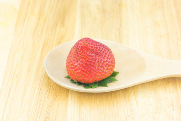 Red berry strawberry isolated on wood background
