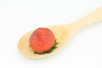 Red berry strawberry isolated on wood spoon