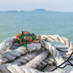 Hand made necklace on the Balaton lake background
