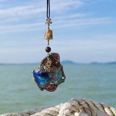 Hand made necklace on the Balaton lake background