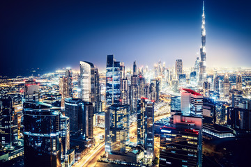 Fototapeta na wymiar Scenic nighttime skyline: big modern city with illuminated skyscrapers. Business bay, Dubai, UAE.