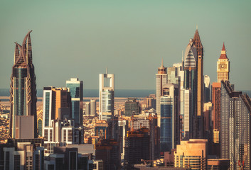 Fototapeta premium Fantastic architectural background. Clouse up view of Dubai towers at sunset. Vintage effect.