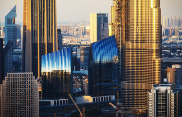 Naklejka premium Beautiful architectural background. Close-up view of Dubai towers at sunset. Film effect.