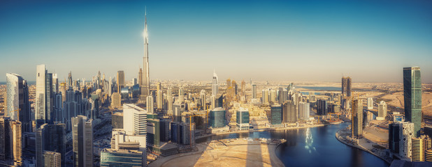 Scenic panoramic view of Dubai modern architecture at sunset. Aerial daytime cityscape with downtown skyscrapers.