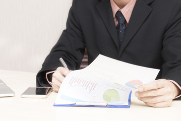 Young asian businessman working in an office.