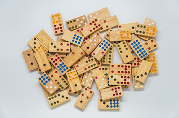 Lots of wooden dominoes on white background with selective focus