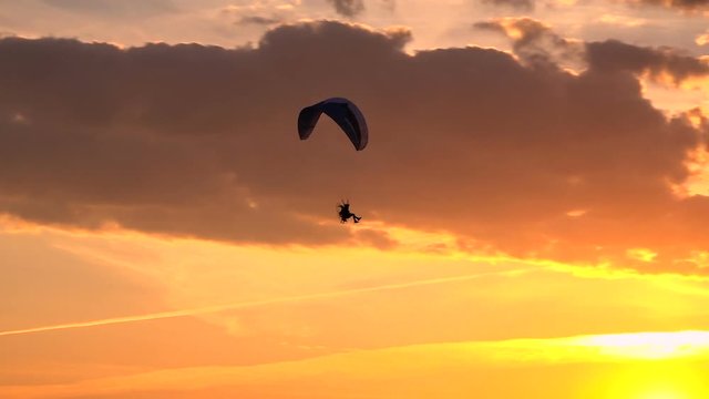 Paramotor Flying at Sunset and Beautiful Clouds