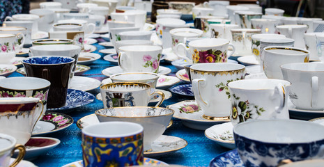 old antiques porcelain china cups and saucers at flea market