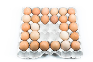 Eggs in paper tray on white background,Brown eggs in an egg carton