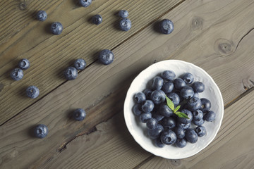 blueberries on rustic table / overhead portrait of blueberries on wood top