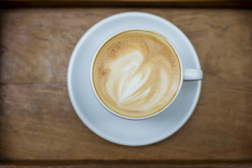 hot latte art on wood table background