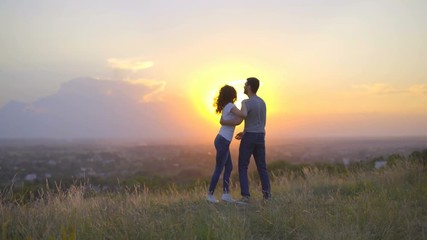 4 in 1 video! The couple play on the background of the sunset. Wide angle. Real time capture. Crane shot with camera pitch