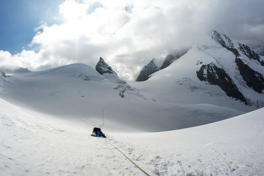 Mountain climber collapsed on snow in Swiss Alps, Piz Bernina, Switzerland