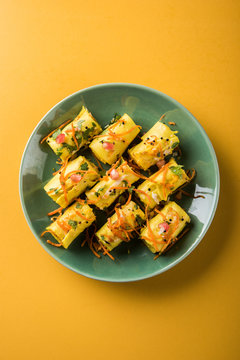 Indian gram flour snack snack called Khandvi or suralichya vadya, selective focus