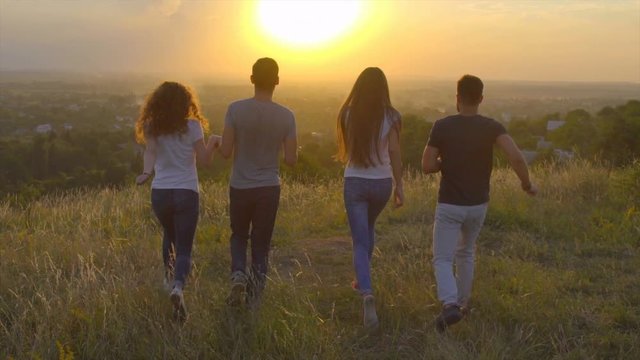 3 in 1 video! The people jump on the background of sunset. Wide angle. Slow motion. Crane shot with camera pitch