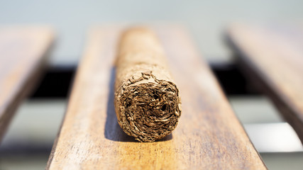 Cuban cigar resting on a wooden surface