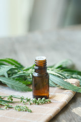 cannabis essential oil container with cannabis leaves and cannab