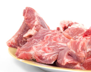 Peaces of pork on bones on the plate  a white background