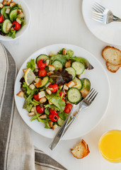 Fresh vegetable salad on a white table. Top view.
