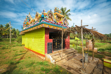 Small colorful decorated hindu temple in indian village