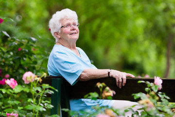 Senior lady in rose garden