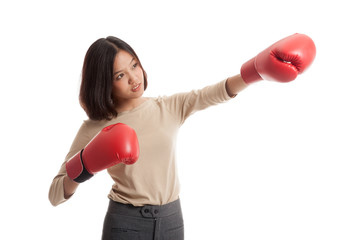 Young Asian business woman with red boxing gloves  isolated on white background