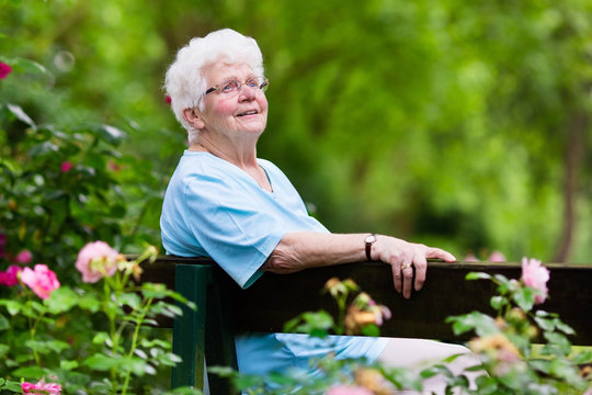 Senior Lady In Rose Garden